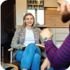 Female mental health professional smiling while helping a patient.